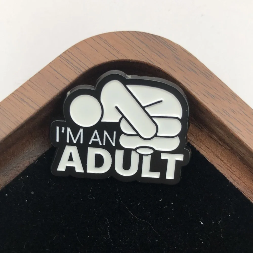 3/$25 “I’m An Adult” with the adult laying in the fetal position. Unisex pin